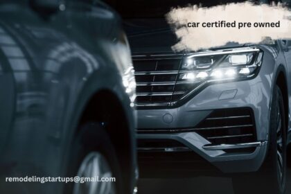 A beautiful shiny car certified pre owned vehicle parked outside a modern dealership showroom