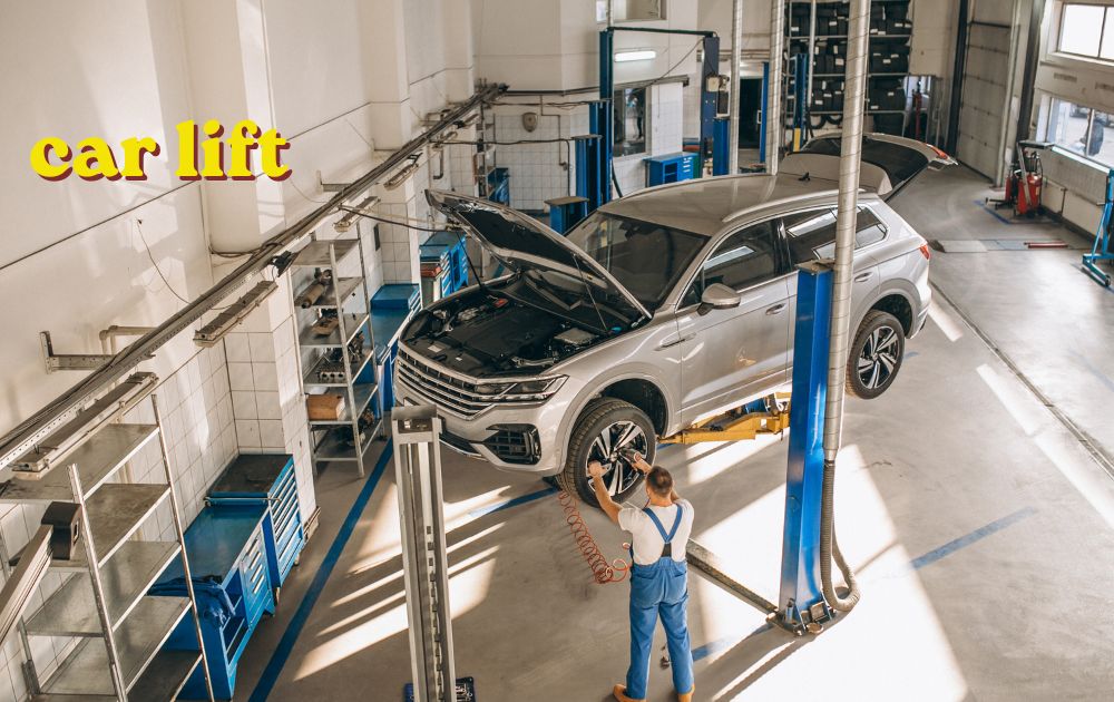 Red two-post car lift raising a vehicle in a workshop