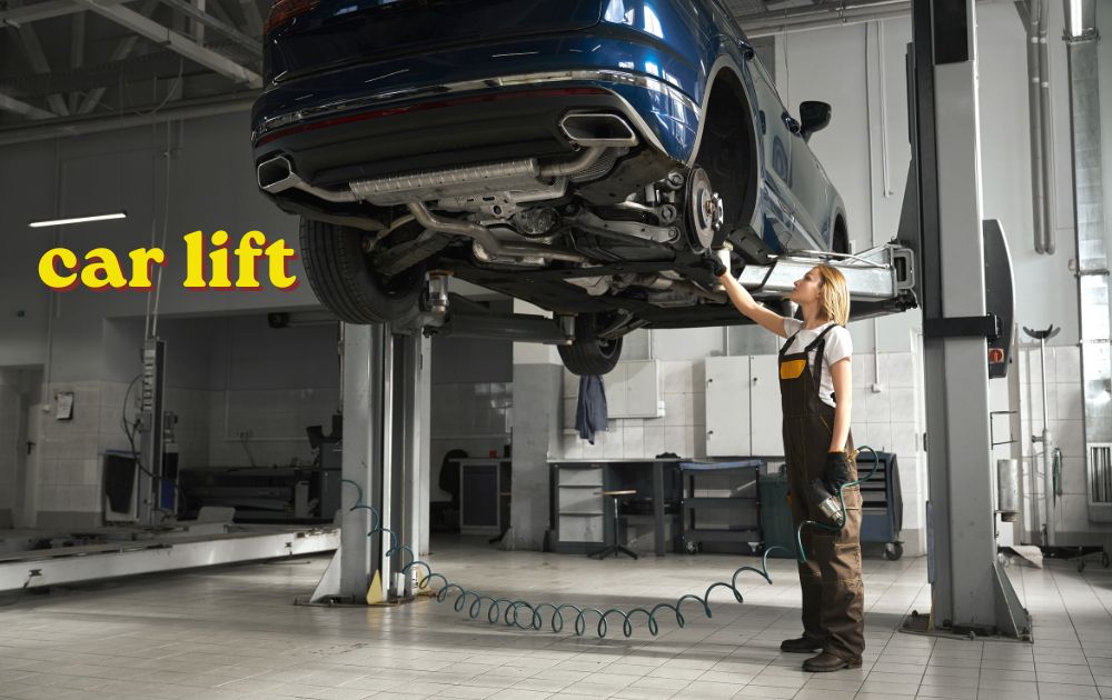 Red two-post car lift raising a vehicle in a workshop