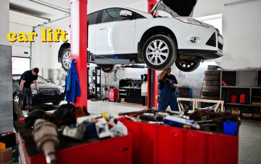 Red two-post car lift raising a vehicle in a workshop