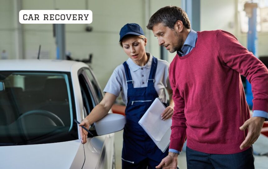 Professional car recovery flatbed tow truck transporting a broken down vehicle safely on a UK road