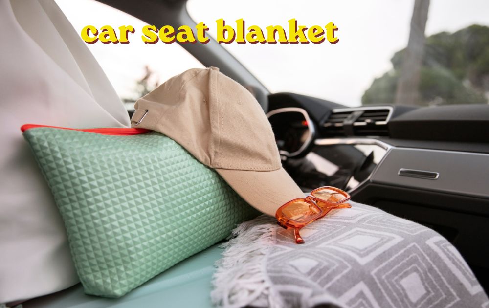 Newborn baby wrapped in a car seat blanket resting safely inside a rear facing car seat