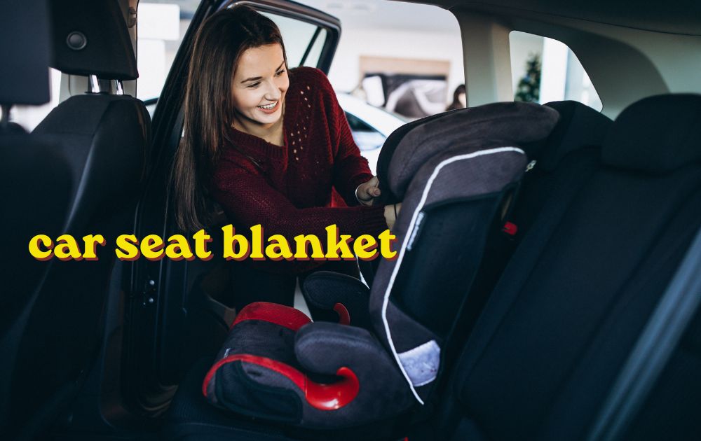 Newborn baby wrapped in a car seat blanket resting safely inside a rear facing car seat
