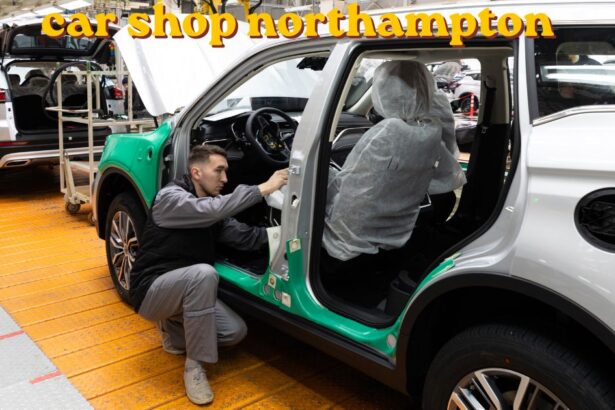 Mechanic working on a car engine inside a car shop Northampton garage