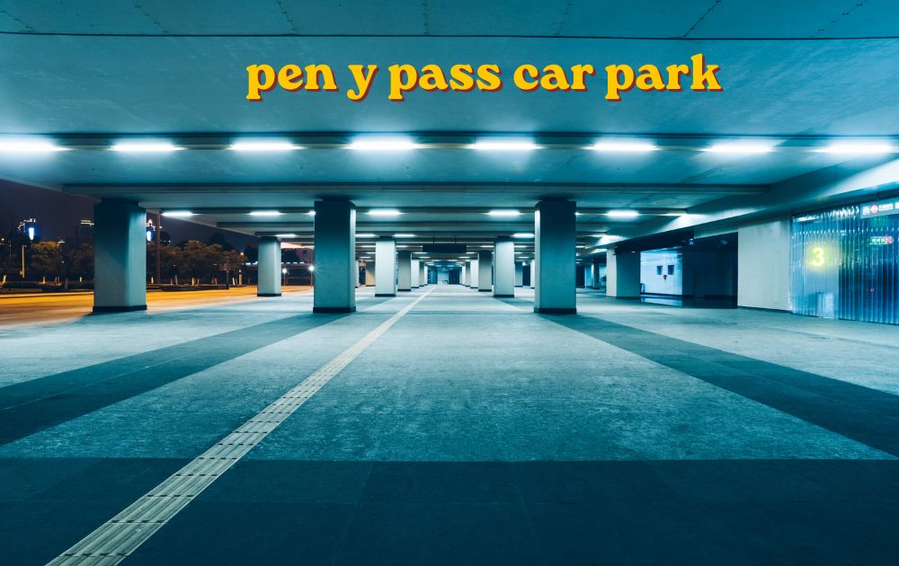 Cars parked at pen y pass car park with Yr Wyddfa mountain in the background