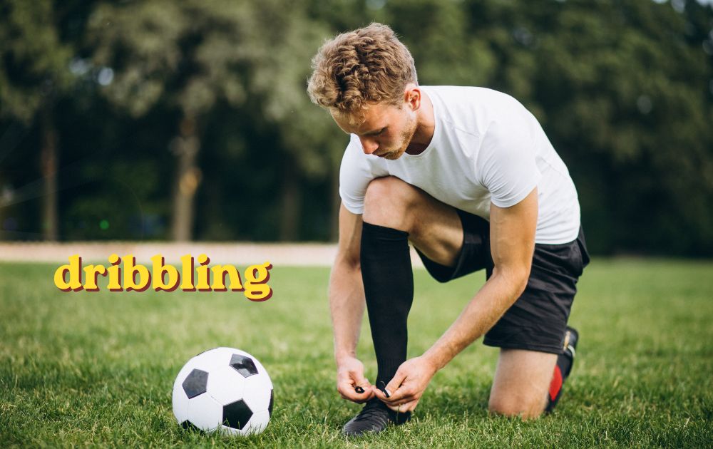 Football player practicing close ball control while dribbling past a defender on the pitch