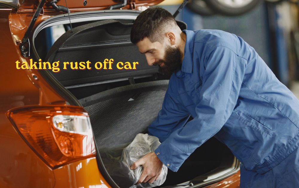 taking rust off car door panel with sandpaper and rust remover in a home garage